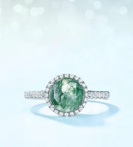Macro shot of silver ring with green moss agate stone and small zircon accents
