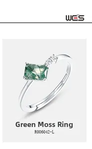 Detail of green moss agate ring with silver band and sparkling side zircons