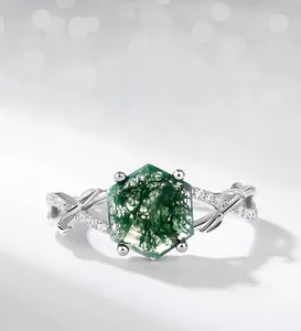 Macro shot of hexagon-cut moss agate ring with silver leaf design and small diamonds