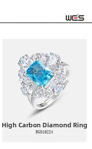 Macro shot of rectangular blue gem ring with radiant halo of pear-cut small diamonds