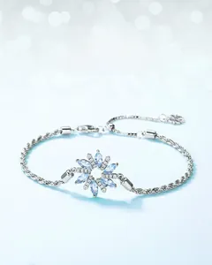 Detailed macro view of S925 silver snowflake bracelet with blue marquise gemstones