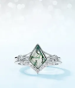 Detailed close-up of a lozenge-cut green moss agate ring with V-shaped silver band
