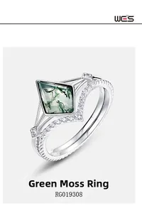 Detailed view of Kite-shaped green moss agate ring set with V-shaped silver diamond band