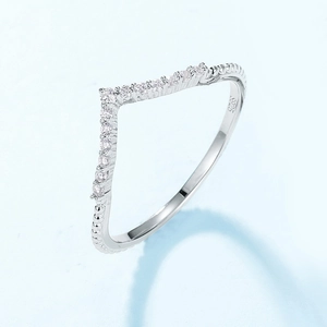 Polished S925 sterling silver V-shaped ring with pavé clear gemstones on a blue background