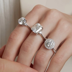 Three Moissanite S925 silver rings with various diamond cuts worn on model hand
