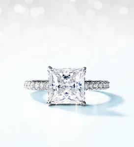 Detail of princess cut moissanite ring with pave setting and four-prong silver band