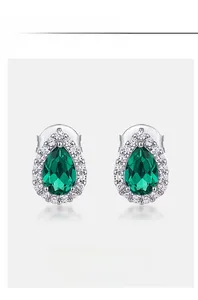 Detailed close-up of pear-shaped lab emerald halo stud earrings in S925 sterling silver