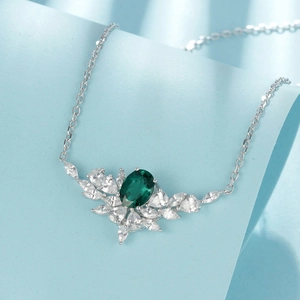 Elegant silver necklace with oval emerald-cut gemstone and marquise white stone cluster