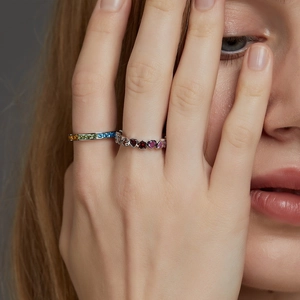 S925 silver ring set with rainbow cubic zirconia and pink heart-shaped stones on finger