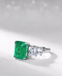 Macro view of emerald-cut green gemstone ring with side-set tapered baguette zircons