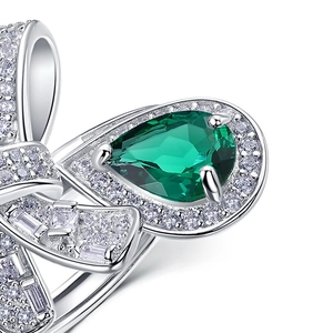Bowknot S925 silver ring featuring a large pear-cut emerald and sparkling diamonds