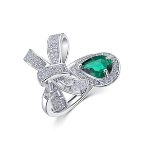 Sparkling S925 silver bow ring featuring a pear-cut emerald and micro-pave diamonds