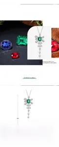 Detailed view of the S925 silver bow pendant with an emerald green laboratory-grown gemstone