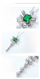 Macro details of S925 silver bow pendant featuring emerald-cut green gemstone settings