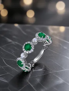 Detailed view of S925 silver ring featuring three oval emeralds and pavé white diamonds
