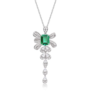 Elegant silver bow necklace with emerald cut green stone and teardrop fringe pendant