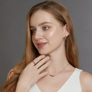 Rainbow cubic zirconia jewelry set including gold necklace, earrings and ring on model