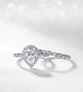Detailed close-up of pear-cut moissanite ring set with wave diamond band in S925 silver