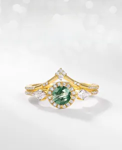 Detail of moss agate ring set with sparkling zircons and a V-shaped band in gold finish