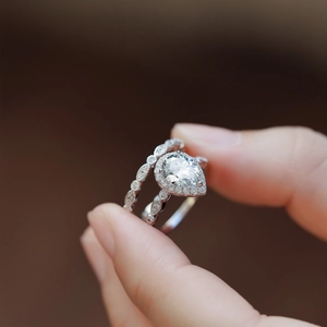 S925 silver pear-shaped moissanite ring set with sparkling side stones shown in detail