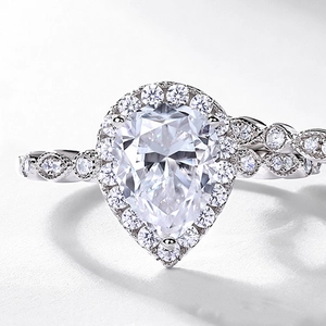 Elegant pear-shaped moissanite ring with halo setting and twisted pave band in S925 silver