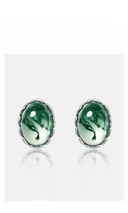 Detailed view of oval green moss agate stones set in vintage silver earring studs