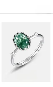Close-up of moss agate ring in S925 sterling silver with a vintage filigree setting