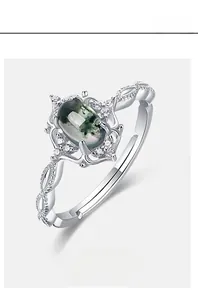 Macro shot of oval green moss agate ring with cubic zirconia accents and S925 silver band