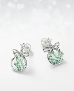 Close-up of bowknot moss agate earrings with silver metal and white zircon inlays