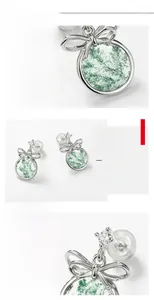 Macro detail of S925 silver moss agate earrings featuring a delicate silver bow design