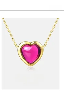 Detailed view of pink heart-shaped synthetic corundum pendant on a gold-plated necklace