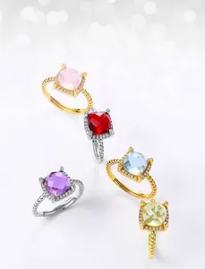 Macro detail of square-cut colorful gemstones in S925 silver rings with halo diamonds