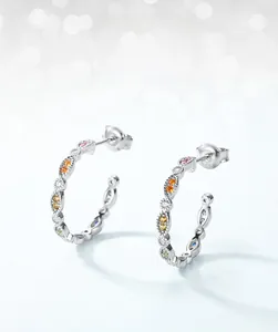 Detail of C-shaped S925 silver earrings with colorful rainbow cubic zirconia stones