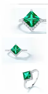 Macro detail of princess cut emerald ring in S925 silver with sparkling halo setting