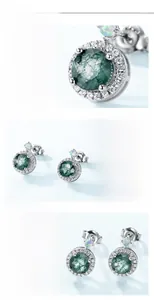 Macro shot of S925 silver earring with moss agate stone and zircon crystal halo