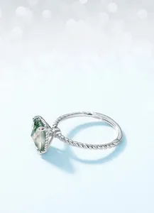 Macro shot of S925 sterling silver hallmark and vintage twisted band on moss agate ring