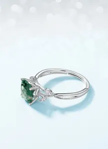 Macro detail of S925 silver leaf ring featuring square green moss agate and side diamonds