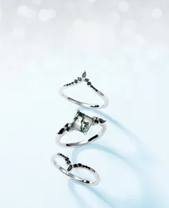 Macro shot of 3pcs S925 silver ring set featuring square moss agate and black accents