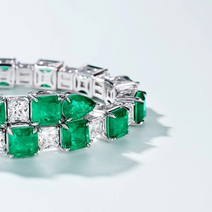 Luxurious S925 silver bracelet featuring emerald-cut green and white gemstones