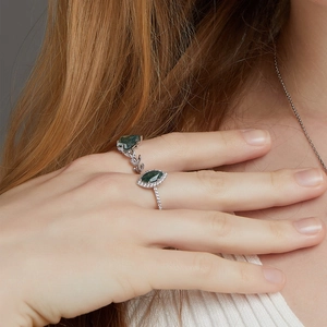 Detail of silver moss agate rings featuring marquise cut stone and olive leaf design