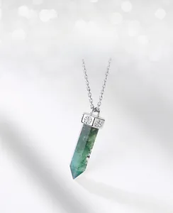 Macro shot of green moss agate pendant with floral silver cap on a fine silver chain
