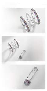 Détail de bagues en argent S925 avec zircons arc-en-ciel et broche épingle assortie