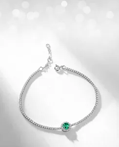 Macro shot of lab-grown emerald bracelet with brilliant silver zirconia pave setting