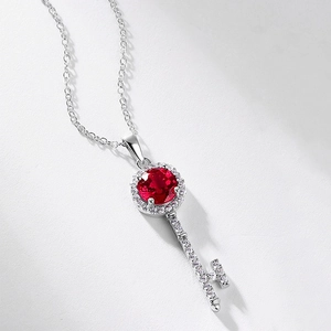Elegant S925 silver key necklace featuring a red ruby gemstone and sparkling zircon accents