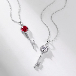 S925 silver key necklaces with red and white gemstones on light grey background