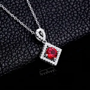 Elegant silver necklace featuring a round red gemstone with a square diamond halo detail