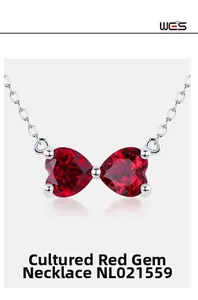 Close-up of bowknot necklace with two heart-shaped rubies on a S925 silver chain