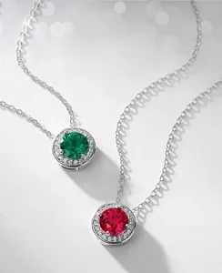 Macro detail of emerald and ruby round pendants with sparkling white zircon stones