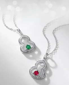 Close-up of lab-grown emerald and ruby gourd pendants with full pavé cubic zirconia