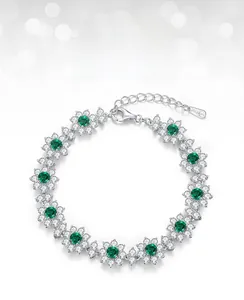Macro shot of S925 sterling silver bracelet with floral lab emerald and zircon inlays